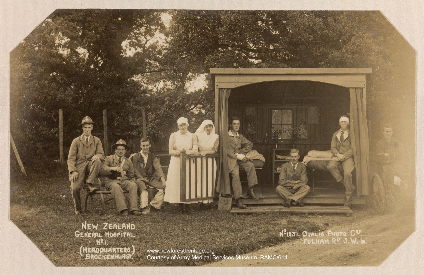 Patients and nurses in and around outside 'hut' room. 'Getting fresh air' at the No.1 NZ General Hospital. 1918