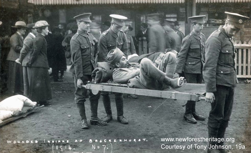 Wounded Indian soldier being carried on a stretcher, Brockenhurst Station. 'Wounded Indians at Brockenhurst. 1914. No.7'