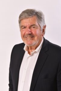 a man in a navy suit and white shirt