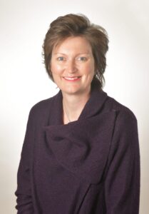 head & shoulders of a woman in a purple jumper