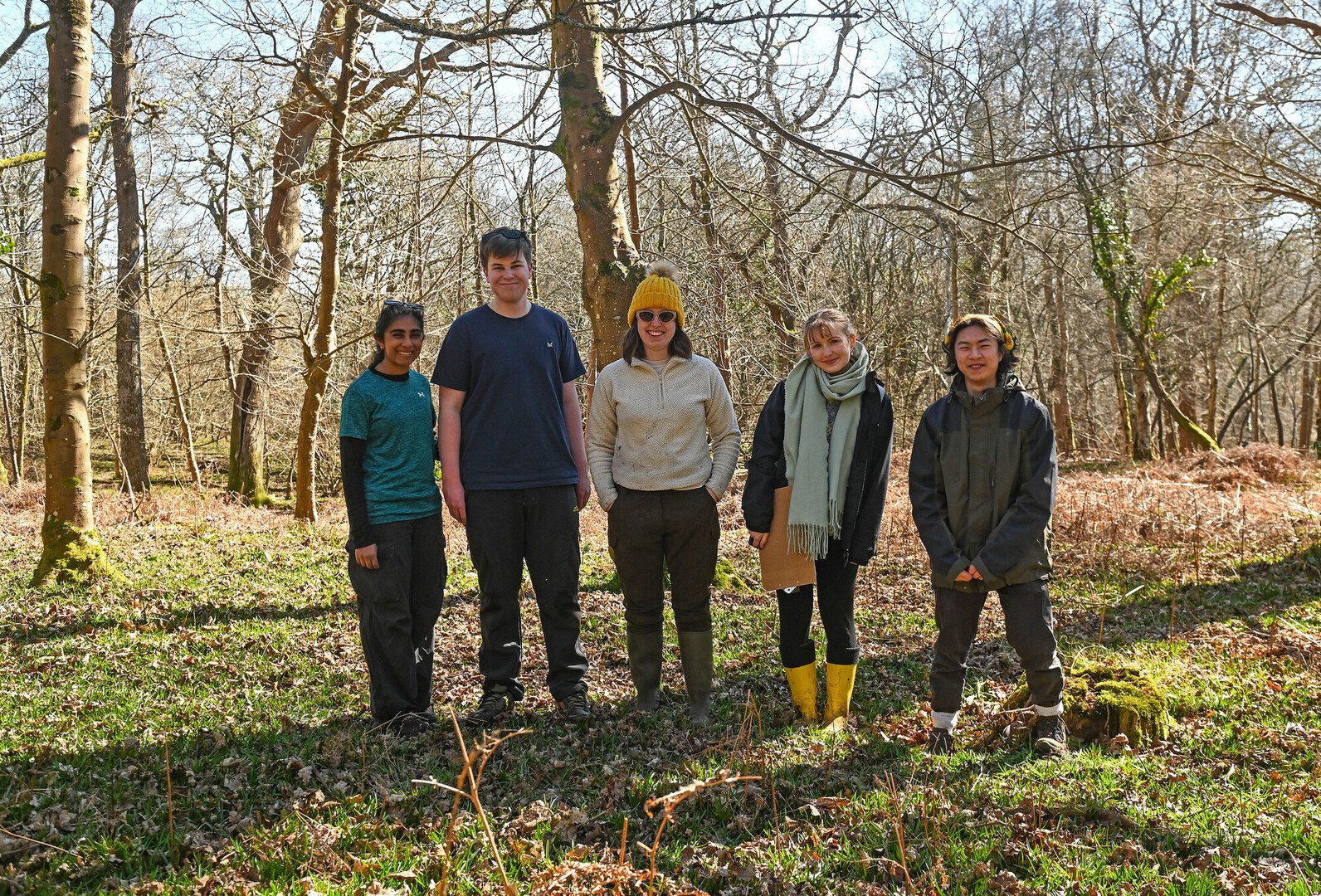 a group of people wearing outdoor gear in a wood