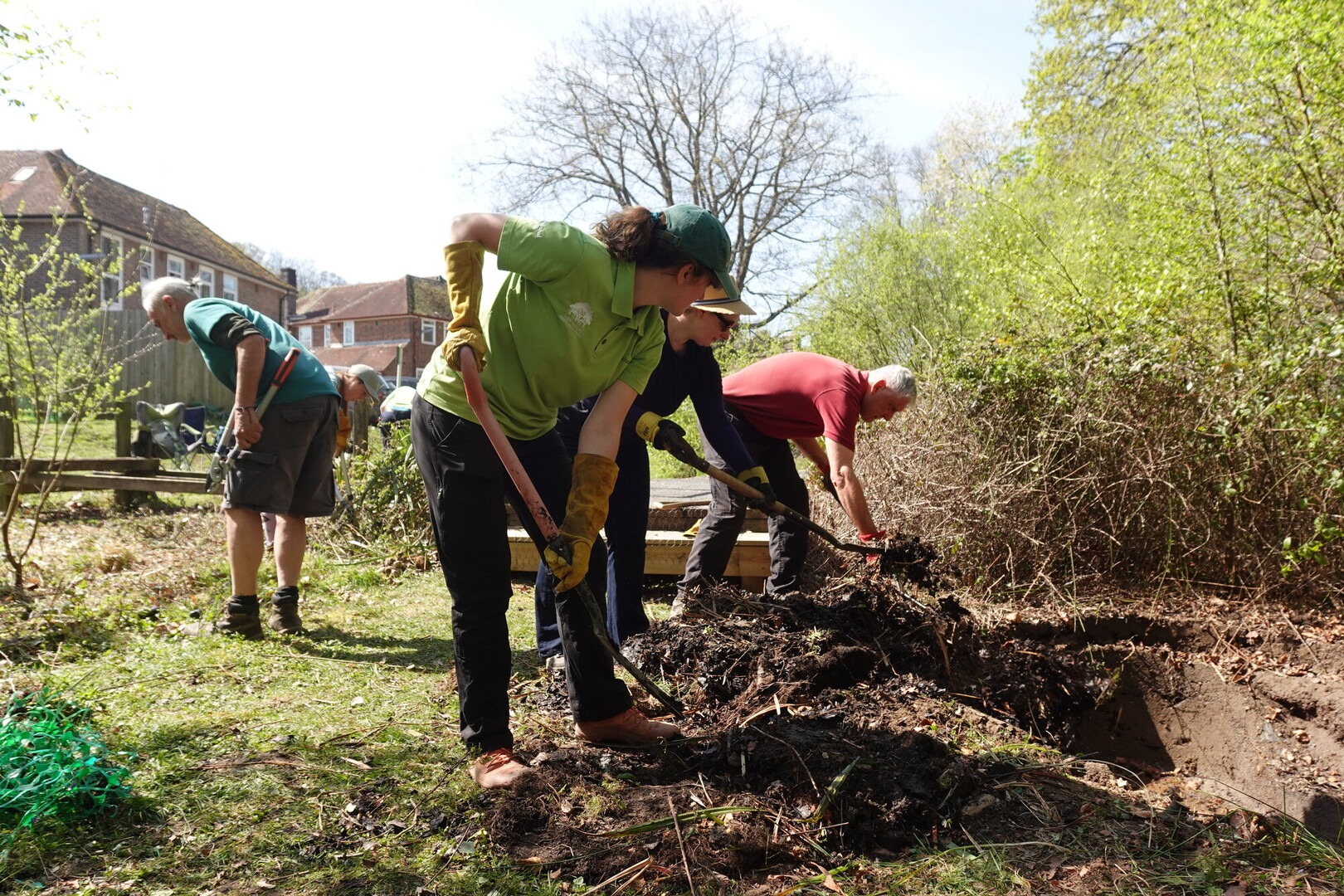 a row of people digging a trench