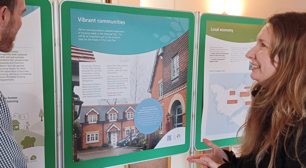 two people looking at public exhibition boards