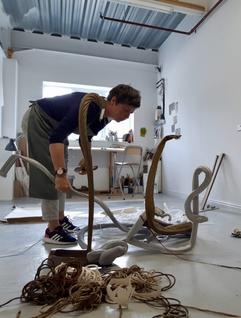 New Forest National Park Artist in Residence Alex Julyan in a studio working on a sculpture piece