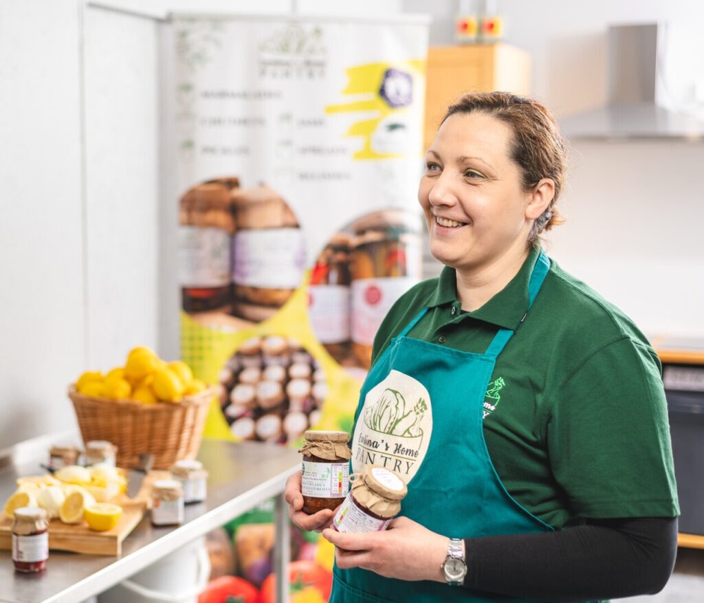 Lady holding jam and chutney jars