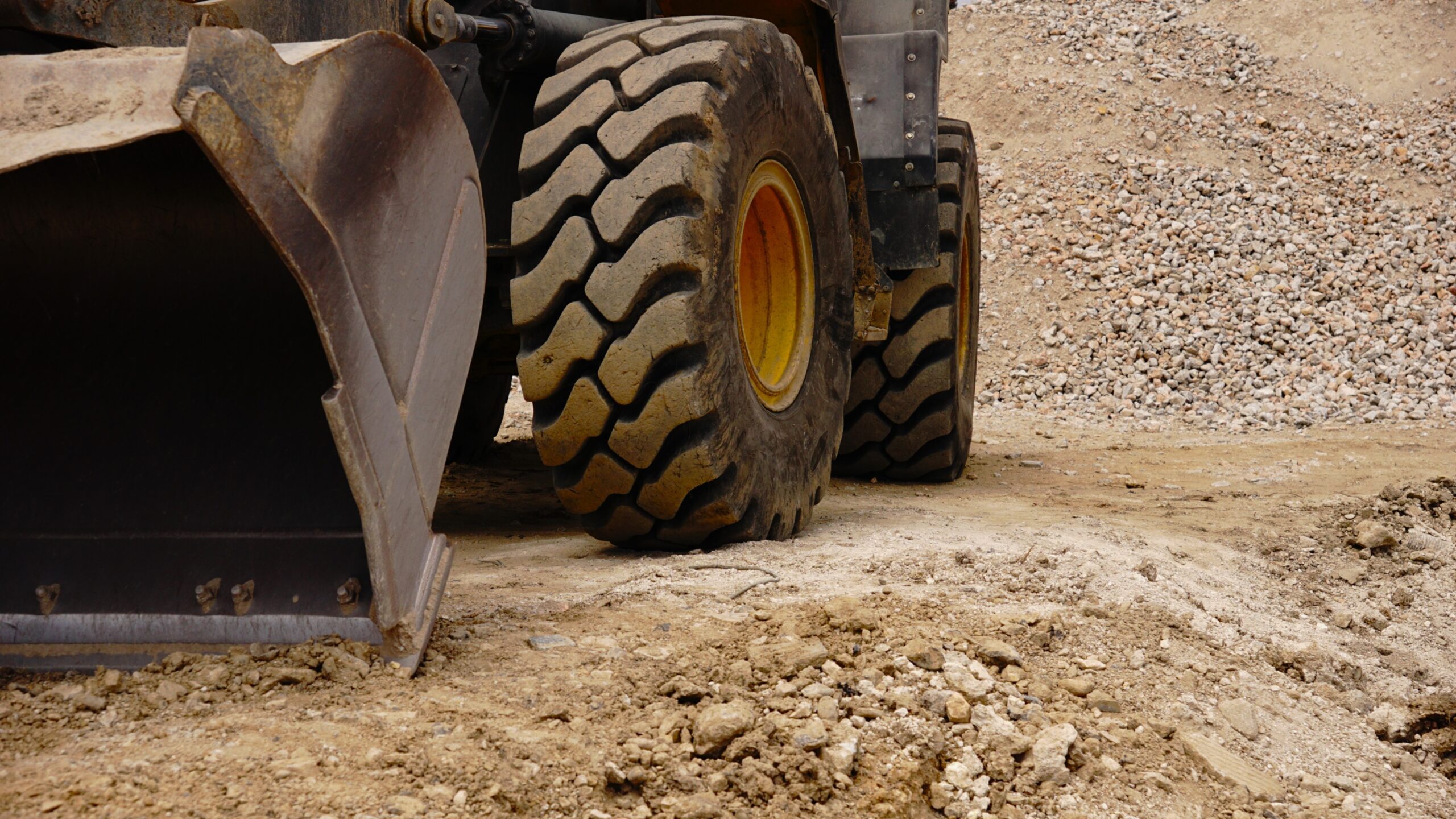 Gravel truck wheel and bucket in a quarry