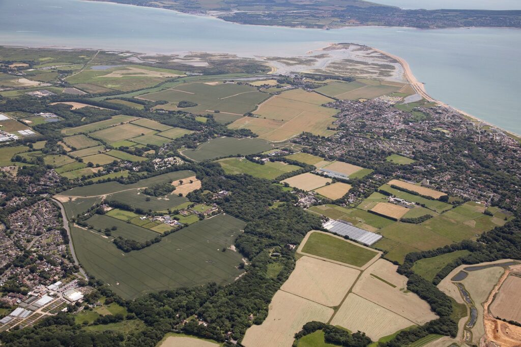 an aerial view of land going out to the coast