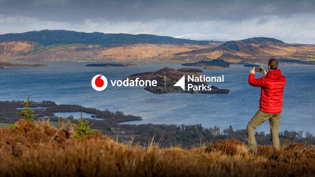 a person taking a photo of a lake