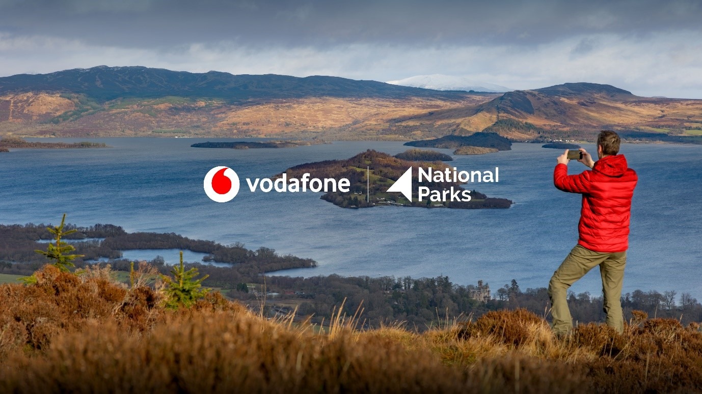 a person taking a photo of a lake