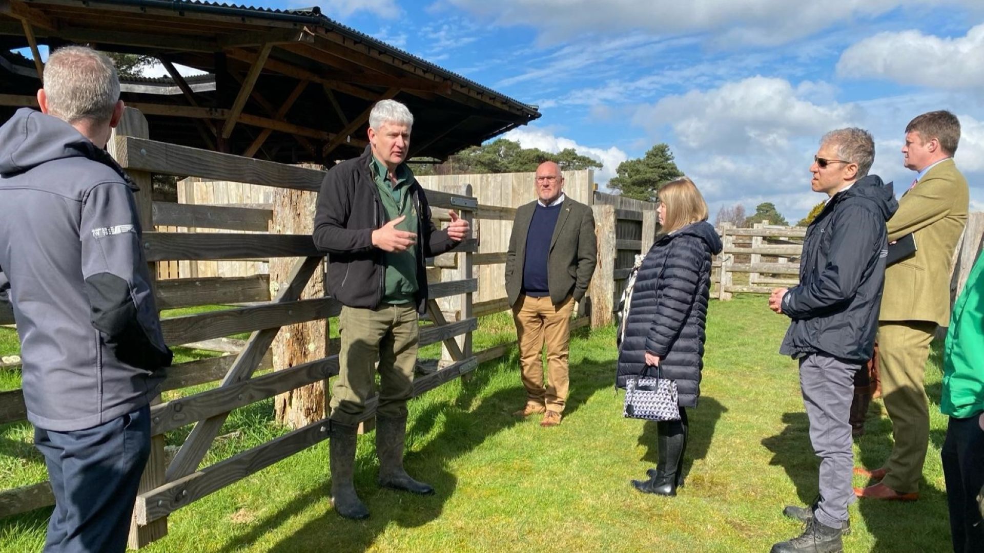 people talking by a gate
