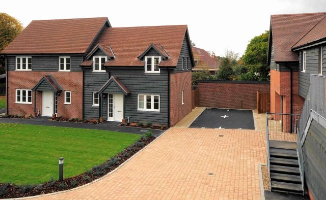 two new houses and a gravel drive