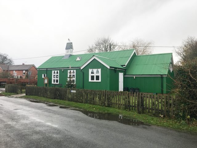 a green metal church