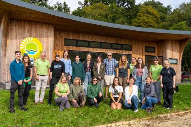 a group of people outside a wooden building