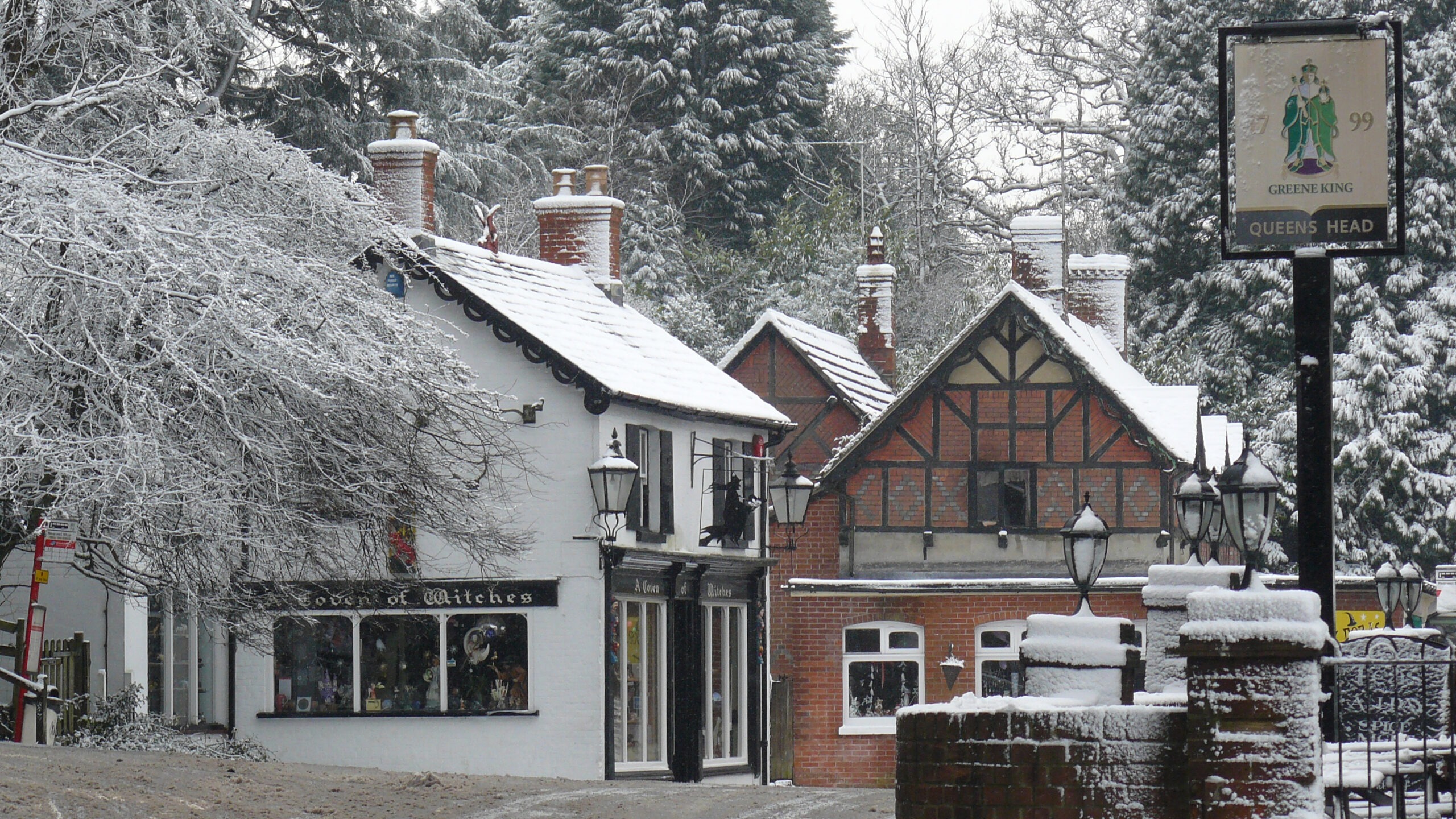 snow covered shops in an English village