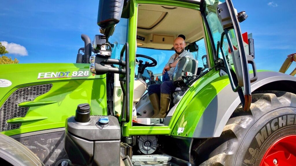 A person sitting in a green tractor