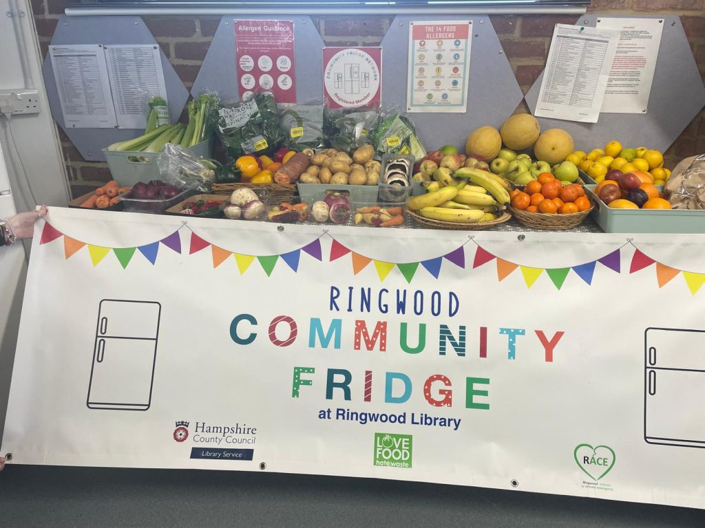 a banner saying community fridge with produce behind