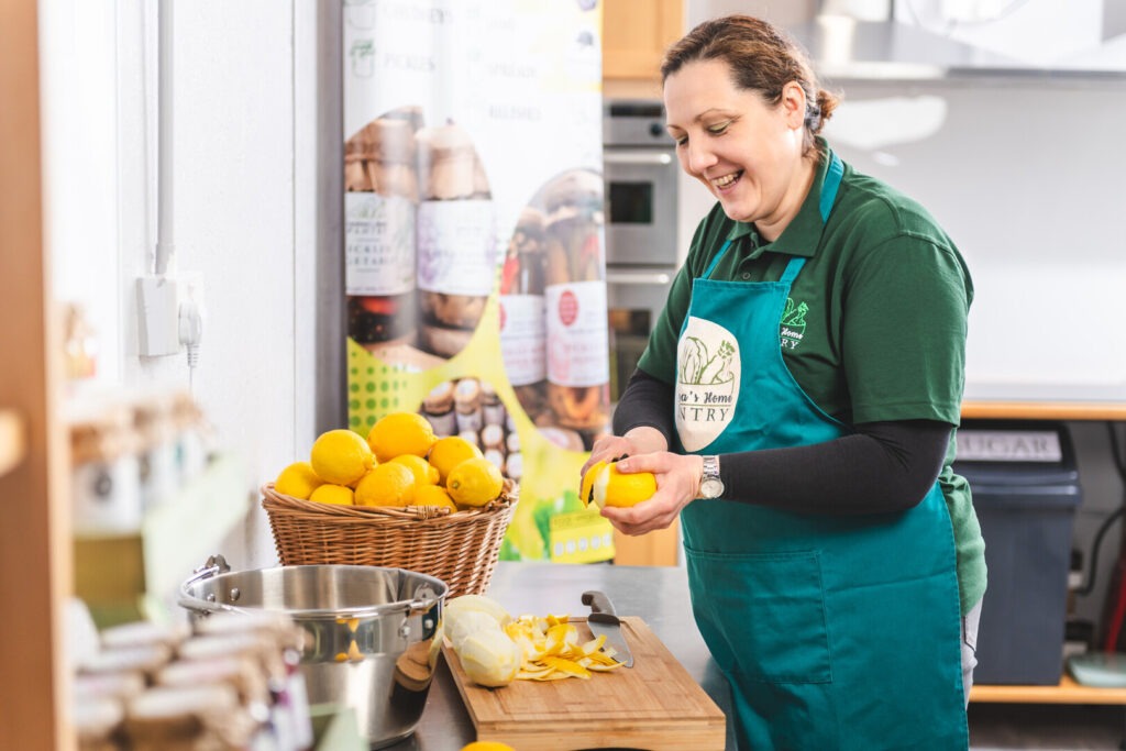 Lady chopping oranges for chutney
