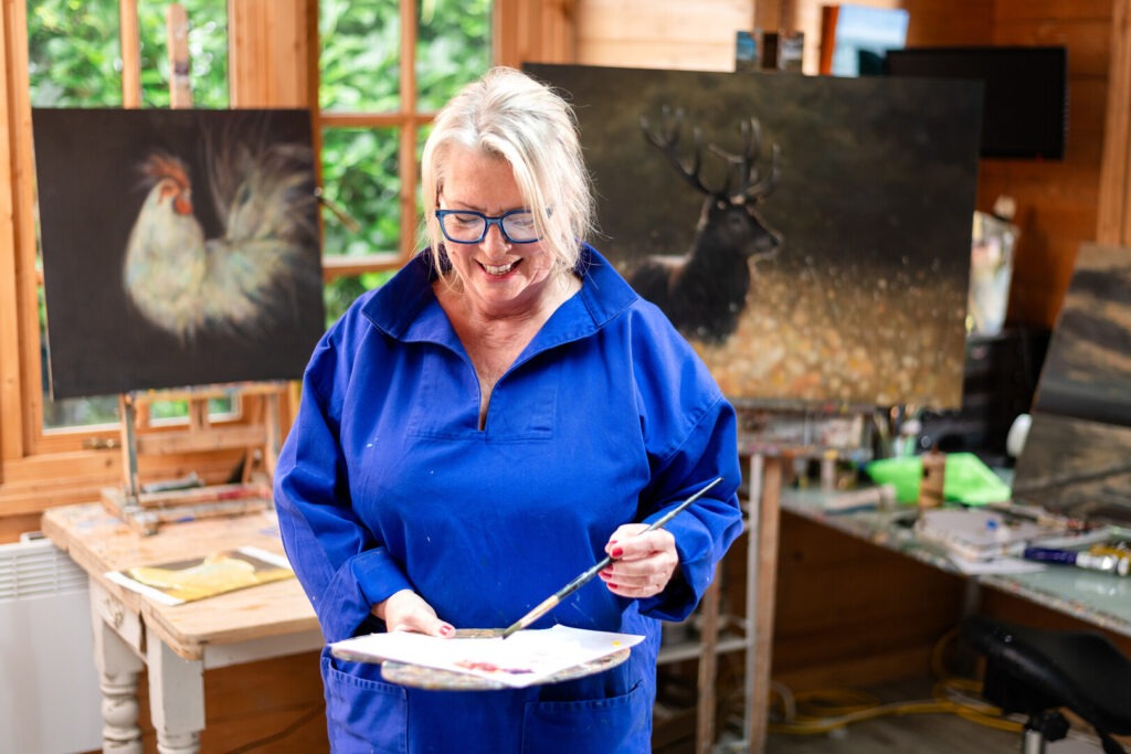 artist painting in her studio