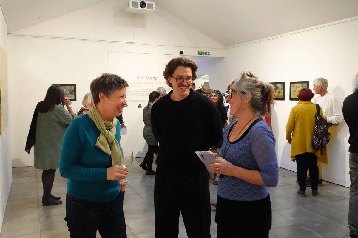Current New Forest National Park Artists in Residence Alex Julyan (left), Ben Adamson (middle) and past Artist in Residence Melanie Rose (right) at Melanie's exhibition in October 2023.
