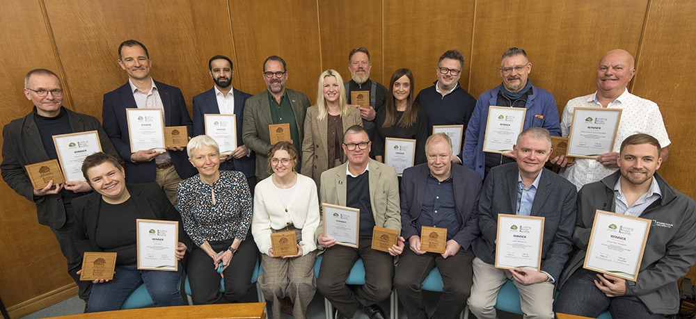 Group of award winners holding certificates and wooden plaques at New Forest National Park Authority Building Design Awards 2025