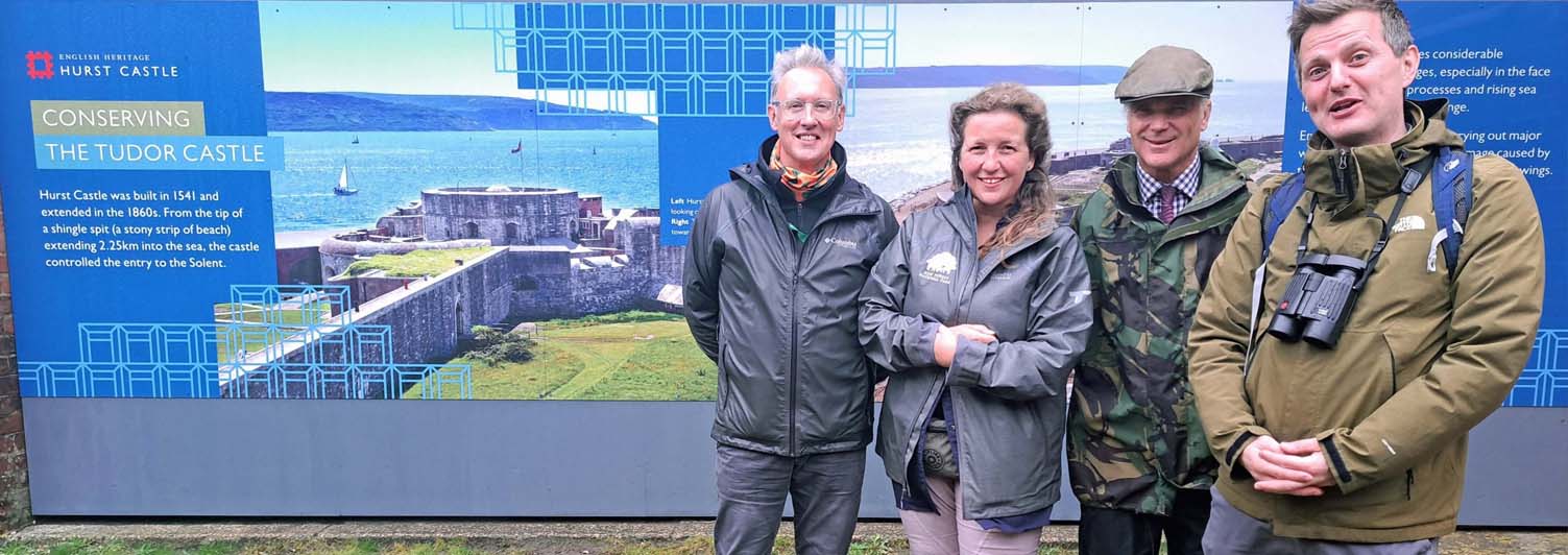 group of people standing outside with display board behind
