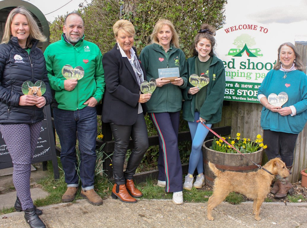 group of people with dog at campsite