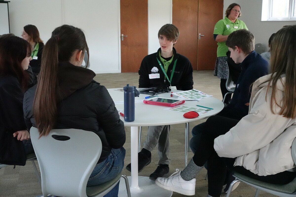 Josh gives advice to a group of teenagers during a youth volunteering workshop at the New Forest National Park Volunteer Fair 2024