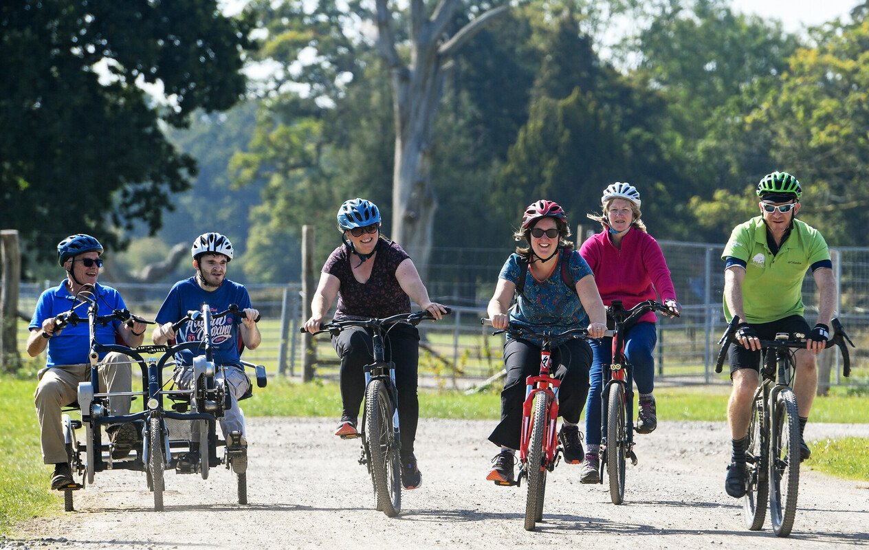 Two people on a tandem bike and four others on two wheeled cycles during Pass the PEDALL 2024