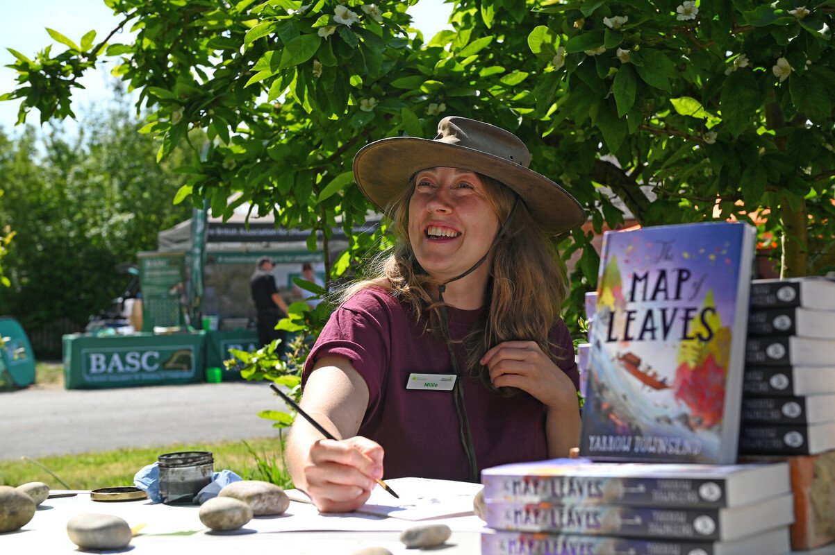CET staff member and New Forest writer in residence Millie Townsend sat at a table painting