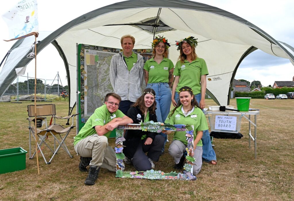 The New Forest Youth Board at New Forest Thrive festival in Ringwood 2025 stand in a group in a tent.