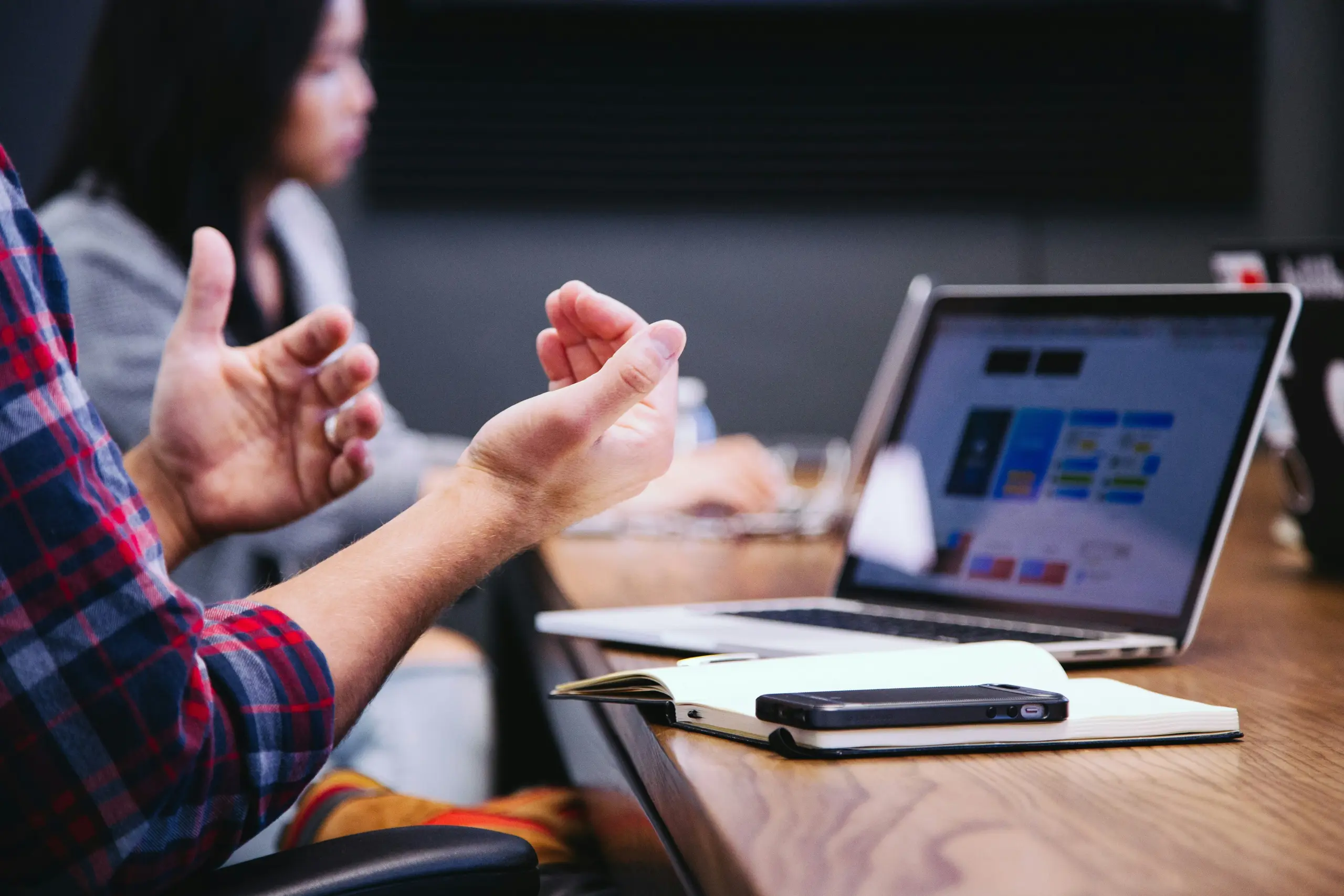 A person discussing decisions with a board in a meeting room